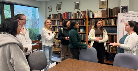 Dr. Droroshow speaks with several of the attendees while standing around a table